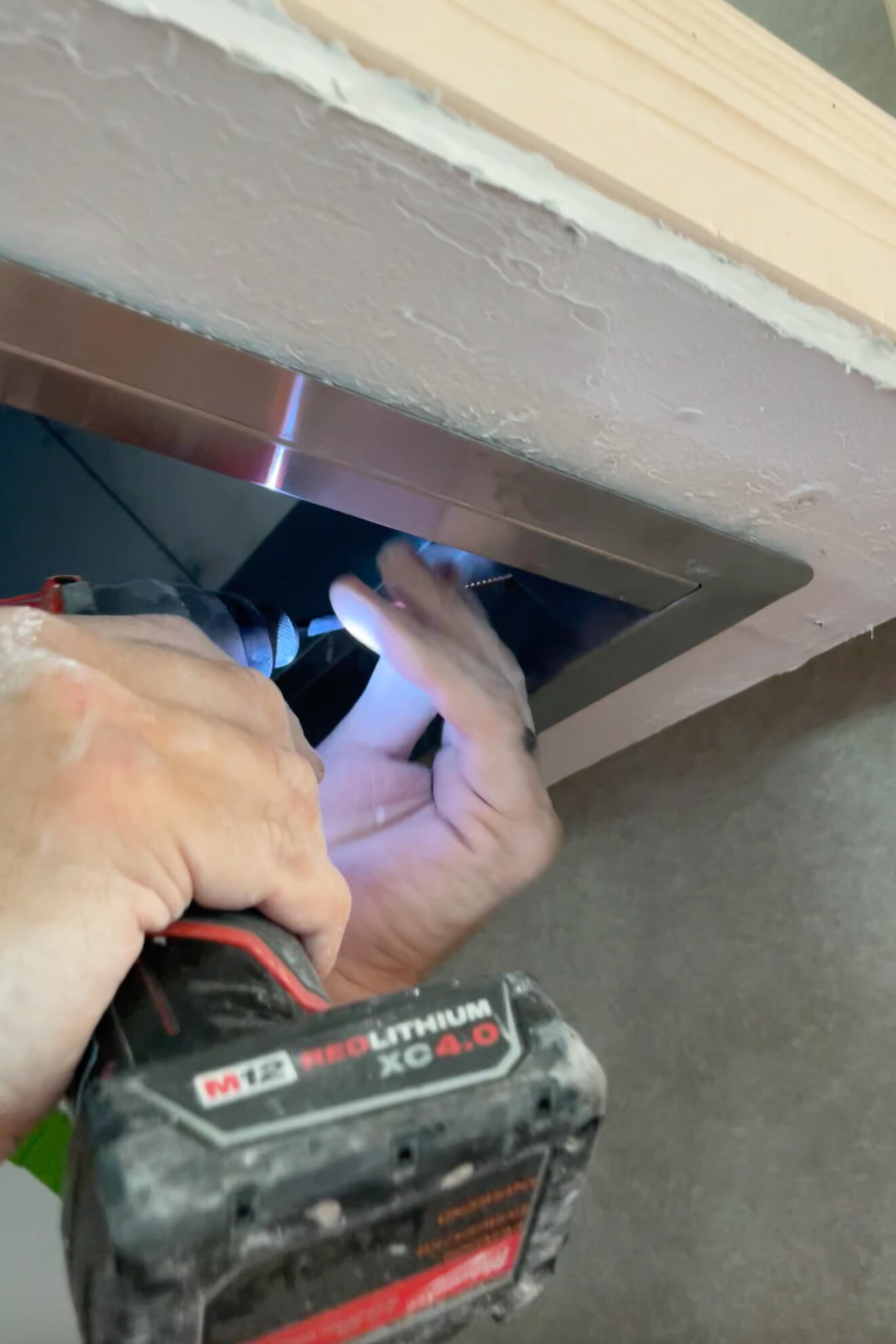Installing a vent hood insert. 